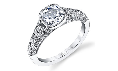 Engagement ring with intricate floral metalwork, plus a bezel center diamond