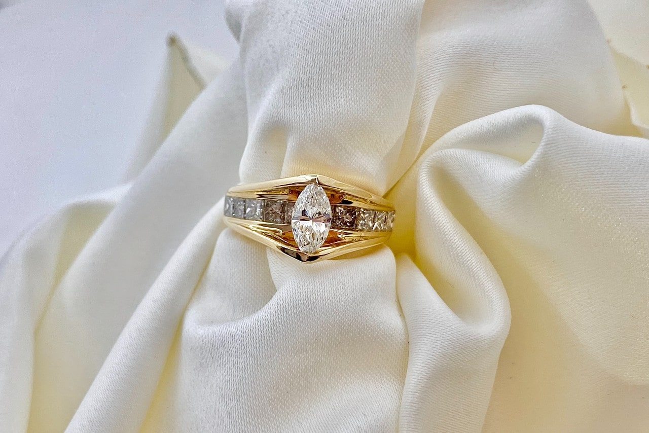 Yellow gold engagement ring with a marquise cut diamond