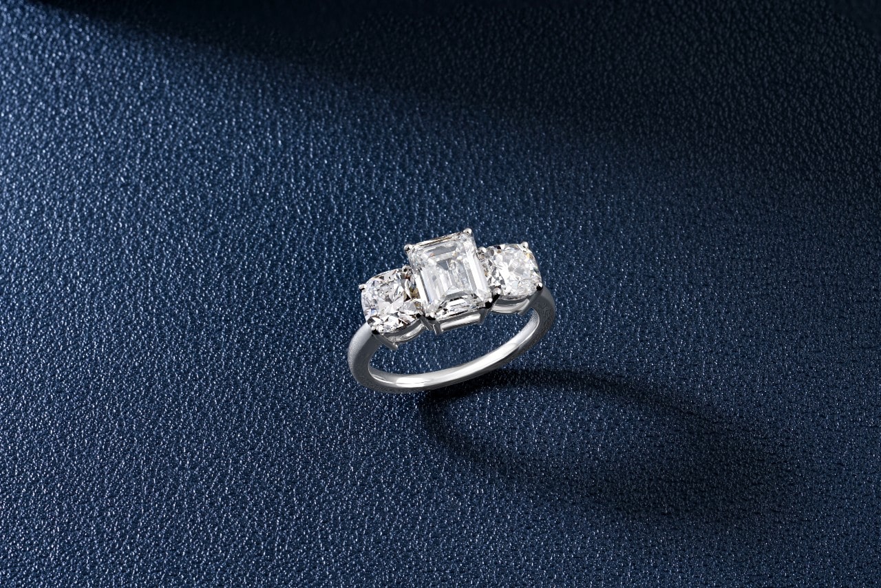 An engagement ring with three center diamonds