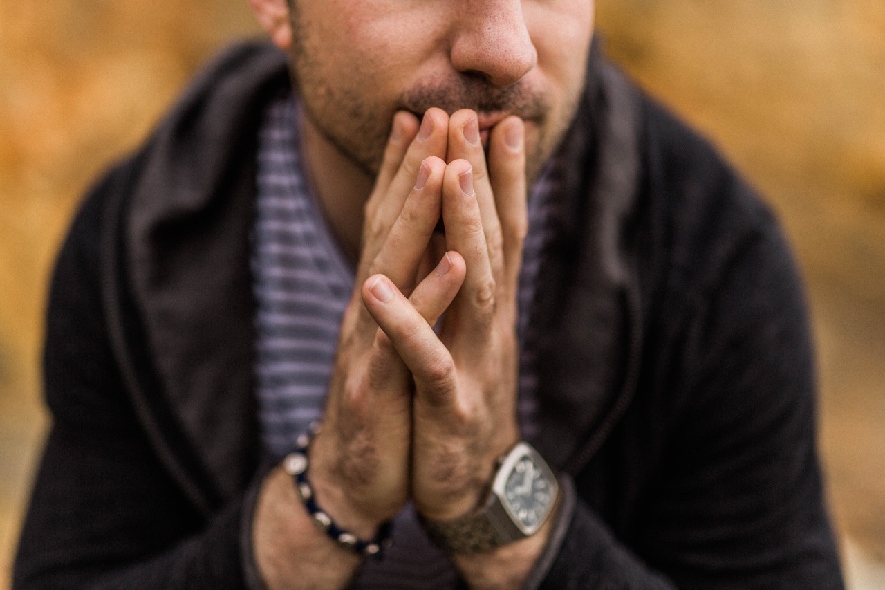 A dad sits down and shows off his watch and bracelet