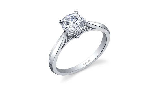A silver solitaire engagement ring by Sylvie with details on the ring’s profile