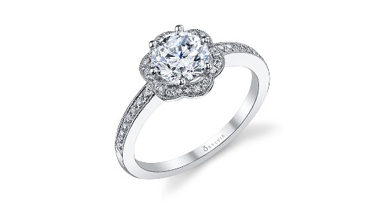 A silver engagement ring by Sylvie with a halo setting shaped into a flower