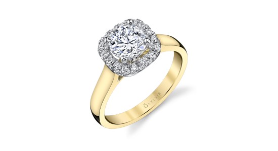 A yellow gold engagement ring by Sylvie with a halo setting