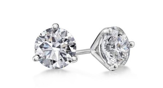 a pair of prong-set round cut diamond stud earrings