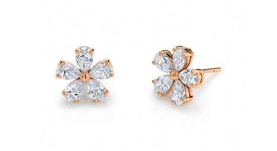 a pair of gold diamond stud earrings featuring diamonds arranged into a flower