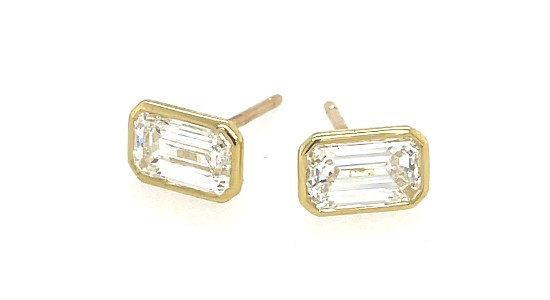 a pair of yellow gold bezel set emerald cut diamond stud earrings