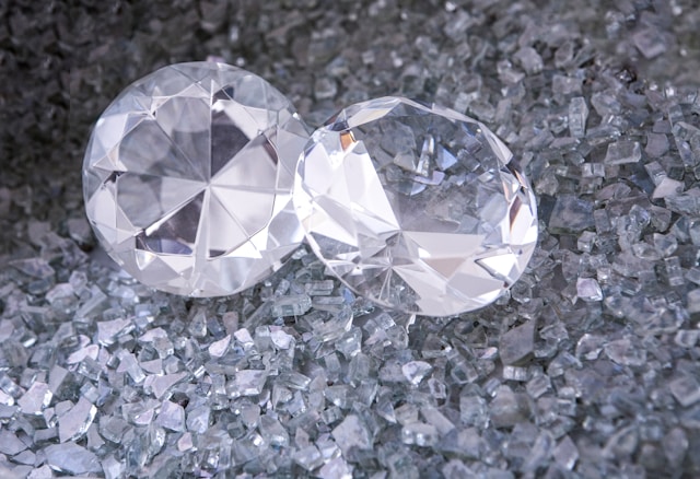 two round cut diamonds sitting amidst diamond shavings